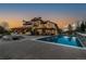 Backyard view showcases a luxurious pool, fire pit area, and beautiful outdoor space at 8417 High Ridge Ct, Castle Pines, CO 80108