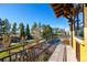 Balcony with wrought iron railings providing a view of the lush landscaping and surroundings at 8417 High Ridge Ct, Castle Pines, CO 80108
