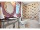 Charming bathroom with decorative mirror, vanity, and tiled shower-tub, exuding elegance and style at 8417 High Ridge Ct, Castle Pines, CO 80108