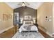 Inviting bedroom featuring vaulted ceiling, stylish decor, and a comfortable king-size bed at 8417 High Ridge Ct, Castle Pines, CO 80108