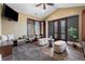 Bonus room or flex space with custom shelving, comfortable seating, and access to the outdoors at 8417 High Ridge Ct, Castle Pines, CO 80108