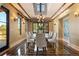 Elegant dining room featuring unique flooring, decorative lighting and seating for eight at 8417 High Ridge Ct, Castle Pines, CO 80108