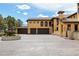 Mediterranean-style house with a fountain, large driveway, and multiple garage spaces at 8417 High Ridge Ct, Castle Pines, CO 80108