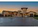 Stunning exterior elevation of an elegant home featuring a circular driveway and fountain at 8417 High Ridge Ct, Castle Pines, CO 80108