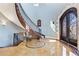 Elegant foyer showcasing curved staircase, stone accents, and custom iron work at 8417 High Ridge Ct, Castle Pines, CO 80108