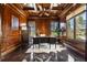 Executive office features wood paneled walls and ceiling, built-ins, and views of the outdoors at 8417 High Ridge Ct, Castle Pines, CO 80108