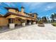 Elegant outdoor patio with a built-in fireplace, seating area, and pergola, perfect for relaxation at 8417 High Ridge Ct, Castle Pines, CO 80108