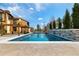 Sparkling swimming pool with a stone waterfall feature, set in a serene and private backyard oasis at 8417 High Ridge Ct, Castle Pines, CO 80108
