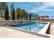 Inviting swimming pool with a stone wall, lush landscaping, and a shaded pergola for relaxation at 8417 High Ridge Ct, Castle Pines, CO 80108