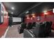 Home theater room with tiered seating, projector screen, and surround sound for cinematic experience at 8417 High Ridge Ct, Castle Pines, CO 80108