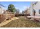 Well-maintained backyard featuring a patio, garden area, and privacy fence at 1832 S Tamarac St, Denver, CO 80231