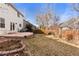 Large backyard featuring a patio, fence, and mature trees, ready for outdoor enjoyment at 1832 S Tamarac St, Denver, CO 80231