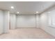 A spacious basement with neutral carpet and white walls featuring recessed lighting at 1832 S Tamarac St, Denver, CO 80231