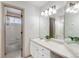 Bright bathroom with a vanity, large mirror, and a combined shower and tub at 1832 S Tamarac St, Denver, CO 80231