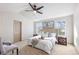 Inviting bedroom with vaulted ceiling, ceiling fan, and windows offering natural light at 1832 S Tamarac St, Denver, CO 80231