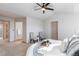 Spacious bedroom featuring a ceiling fan, neutral colors, and door to bathroom at 1832 S Tamarac St, Denver, CO 80231