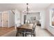 Elegant dining room with a modern chandelier and a view into the adjacent living space at 1832 S Tamarac St, Denver, CO 80231