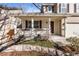 Inviting front porch with white columns and decorative stonework, perfect for relaxing outdoors at 1832 S Tamarac St, Denver, CO 80231