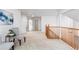 Bright hallway with natural wood railing and neutral colored carpet at 1832 S Tamarac St, Denver, CO 80231