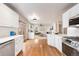 Open-concept kitchen with stainless steel appliances and seamless flow into the living area for easy entertaining at 1832 S Tamarac St, Denver, CO 80231