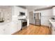 Well-equipped kitchen featuring stainless steel appliances, ample counter space, and white subway tile backsplash at 1832 S Tamarac St, Denver, CO 80231