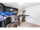 Contemporary kitchenette with black cabinets, stainless steel appliances, and decorative backsplash at 1832 S Tamarac St, Denver, CO 80231