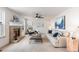 Cozy living room with a brick fireplace, ceiling fan, neutral palette, and comfortable seating area at 1832 S Tamarac St, Denver, CO 80231