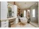 Bright bathroom with a standalone tub, glass shower, and vanity with large mirror at 460 Garfield St, Denver, CO 80206