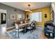 Bright dining room with modern lighting fixture, large windows, and seating for six, creating an inviting atmosphere at 460 Garfield St, Denver, CO 80206