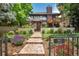 Charming home exterior with professionally landscaped front yard and inviting stone walkway leading to the front door at 460 Garfield St, Denver, CO 80206
