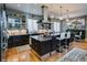Modern kitchen features stainless steel appliances, dark cabinetry, an island with seating, and stylish pendant lighting at 460 Garfield St, Denver, CO 80206