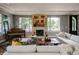 Cozy living room featuring a fireplace, grand piano, and comfortable seating with natural light from large windows at 460 Garfield St, Denver, CO 80206