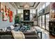 Bright living room with a dark fireplace, a large sectional sofa, and high ceilings with unique chandelier lighting at 460 Garfield St, Denver, CO 80206