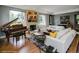 Cozy living room featuring a fireplace, grand piano, and comfortable seating with natural light from large windows at 460 Garfield St, Denver, CO 80206