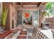 Cozy outdoor patio with dining table and chairs, a hanging basket, and view into the living room at 460 Garfield St, Denver, CO 80206