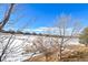 Aerial view of homes and open space with snow at 7879 S Zante Ct, Aurora, CO 80016