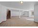 Large basement with carpeted floors, white walls, and a staircase, providing a spacious area for various activities at 7879 S Zante Ct, Aurora, CO 80016