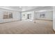 Open basement with plush carpeting and multiple windows and sliding glass door bringing natural light into the space at 7879 S Zante Ct, Aurora, CO 80016
