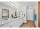 Bright primary bathroom featuring double sinks and modern fixtures at 7879 S Zante Ct, Aurora, CO 80016