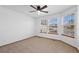 Spacious bedroom with bay windows, neutral carpet, and ceiling fan at 7879 S Zante Ct, Aurora, CO 80016