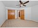 Bedroom with neutral carpet, closet, and a ceiling fan providing comfortable space at 7879 S Zante Ct, Aurora, CO 80016