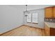 Cozy dining area with modern chandelier and hardwood floors at 7879 S Zante Ct, Aurora, CO 80016