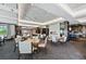 Bright dining room features modern lighting fixtures, stone fireplace, and a bar at 7879 S Zante Ct, Aurora, CO 80016