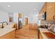 Open kitchen layout featuring wood floors, stainless steel appliances, and ample cabinet space for storage at 7879 S Zante Ct, Aurora, CO 80016