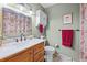 Well-lit bathroom features a marble countertop and red accents at 13225 W Jewell Cir, Lakewood, CO 80228