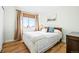 Inviting bedroom featuring hardwood floors, natural light and cozy furnishings at 13225 W Jewell Cir, Lakewood, CO 80228