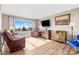 Sunlit living room with hardwood floors, large window and comfortable seating at 13225 W Jewell Cir, Lakewood, CO 80228