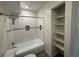 Bathroom with tiled shower/tub and shelving at 3613 S Sheridan Blvd # 16, Denver, CO 80235