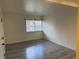 Bedroom featuring neutral walls and gray wood-look flooring, and window at 3613 S Sheridan Blvd # 16, Denver, CO 80235