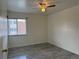 This bedroom features hardwood flooring, a ceiling fan, and a window for natural light at 3613 S Sheridan Blvd # 16, Denver, CO 80235
